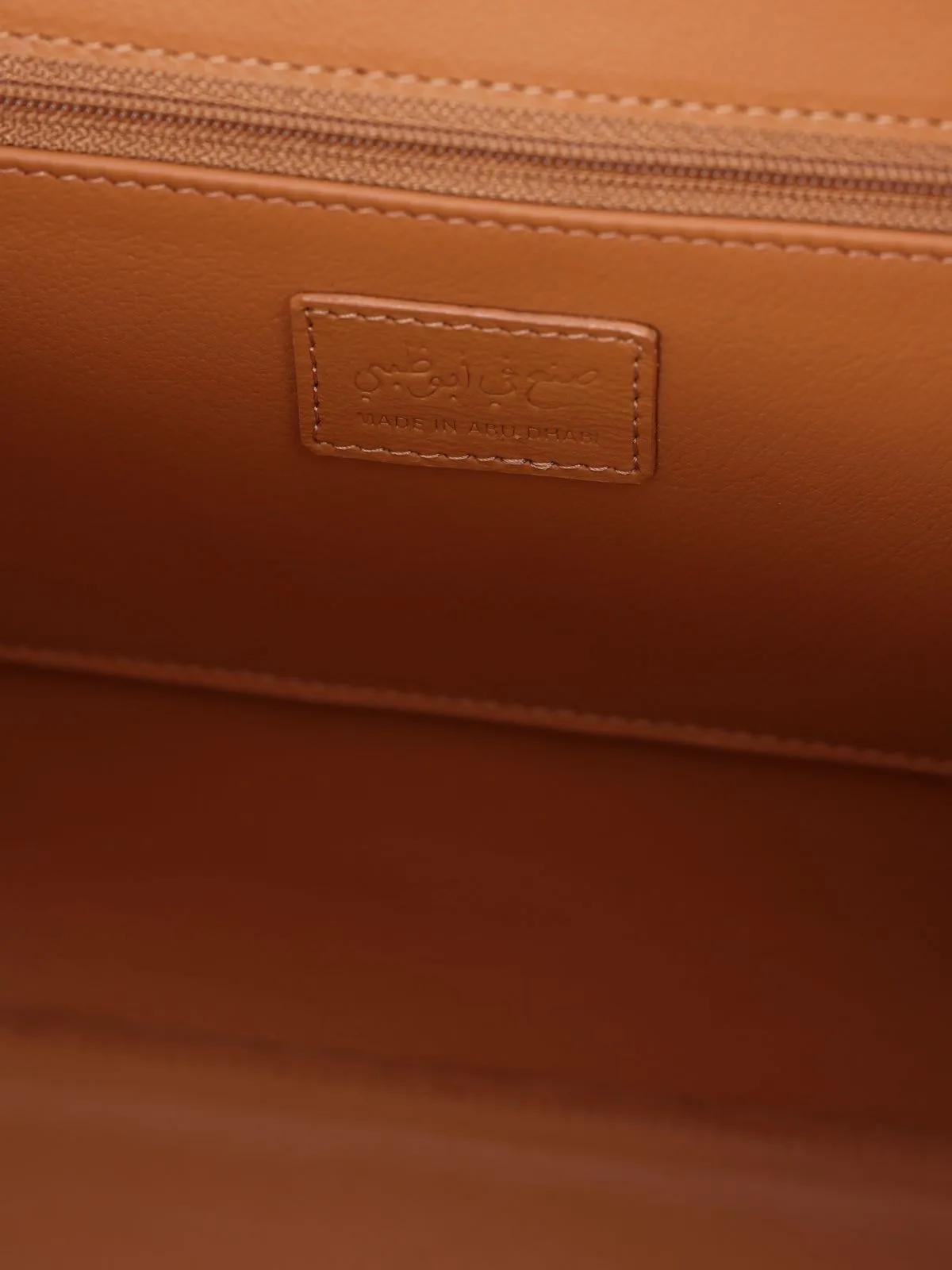 Handbag ÉdÉ interior — Made in Abu Dhabi leather label with Arabic script