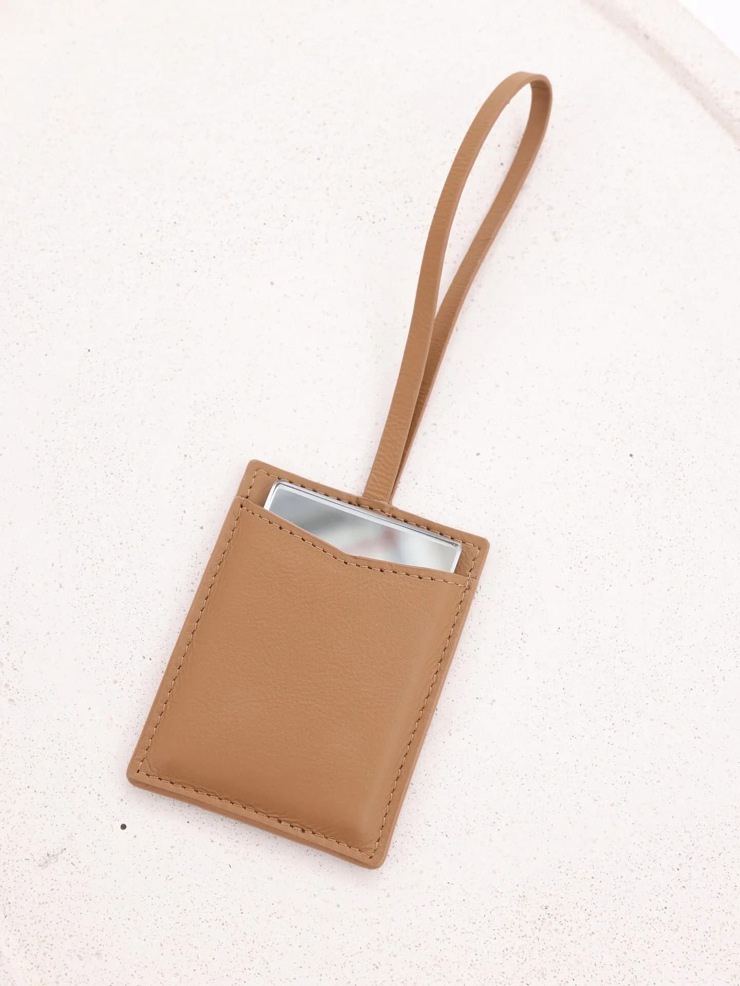 Mirror Pouch with mirror tucked inside — natural leather detail
